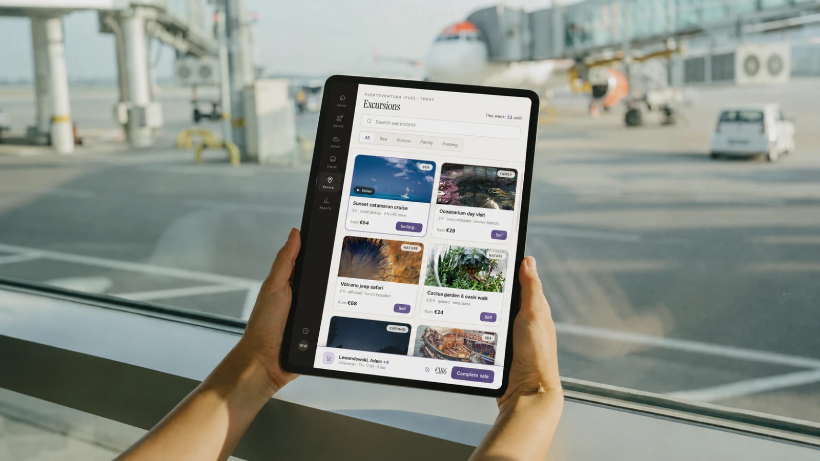 The Excursions tab in a rep’s hands at the gate: local trips browsed and sold from the tablet, offline. Interface reconstruction, 2026, composited into a photo.